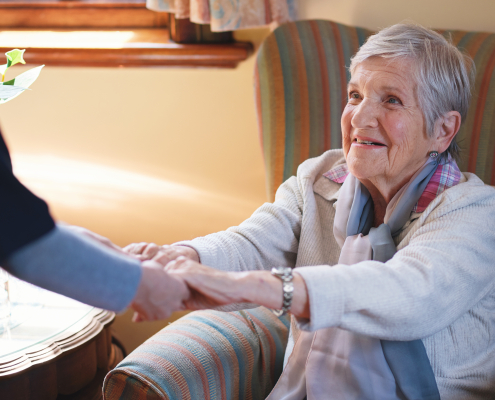 caregiver-helping-senior-woman-at-home-supported-living-and-domiciliary-care-concept