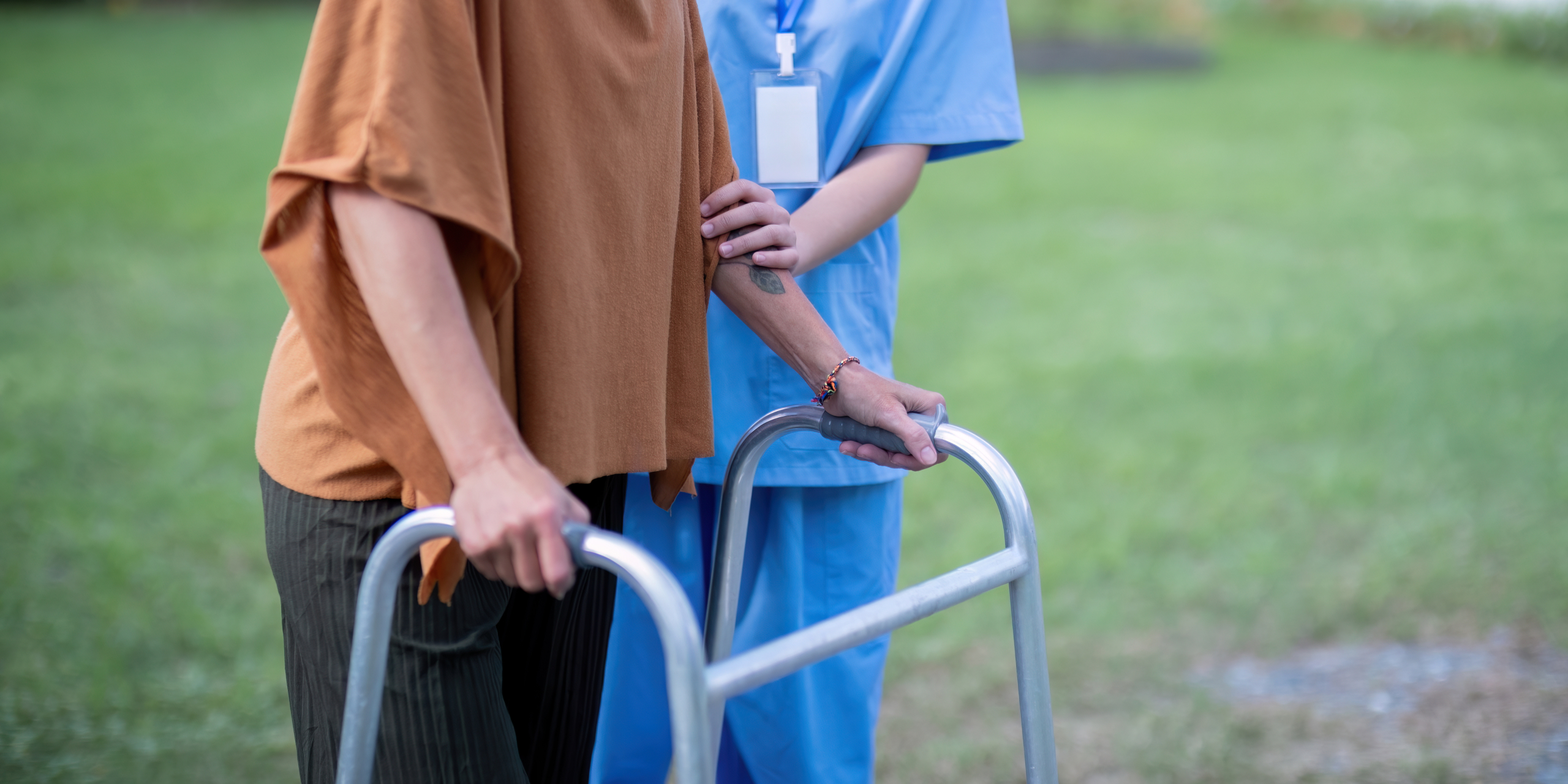 Nurse or caregiver hand on walking frame for support, help or trust moving leg in rehabilitation. Physiotherapy healthcare, Medical caregiver consulting disabled elderly patient at home caring home care