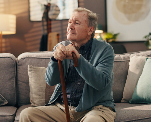 An elderly man at home reflecting quietly, representing the importance of dementia training for care homes in supporting emotional wellbeing and dignity.