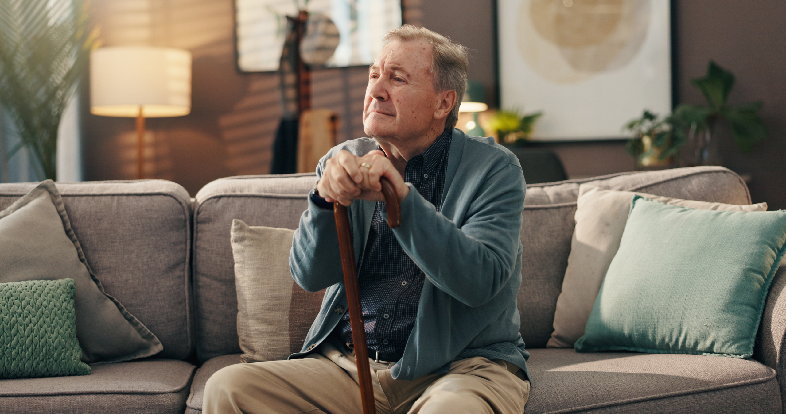 An elderly man at home reflecting quietly, representing the importance of dementia training for care homes in supporting emotional wellbeing and dignity.