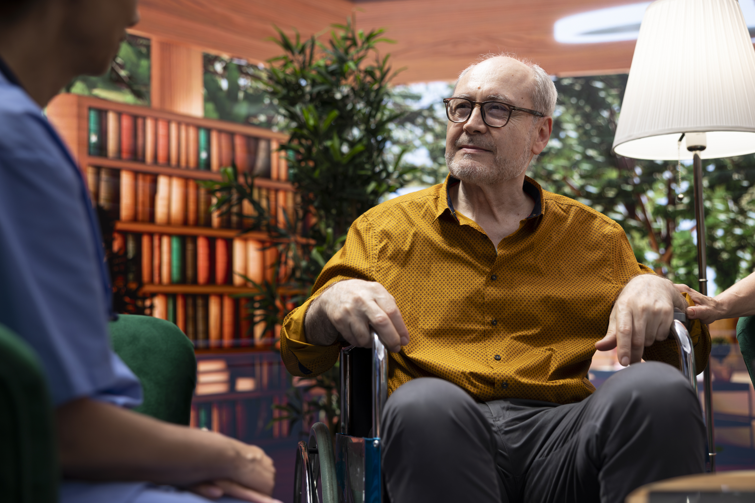 Care provider discussing specialist dementia training with an elderly man in a wheelchair and his supportive wife Care provider discussing specialist dementia training with an elderly man in a wheelchair and his supportive wife