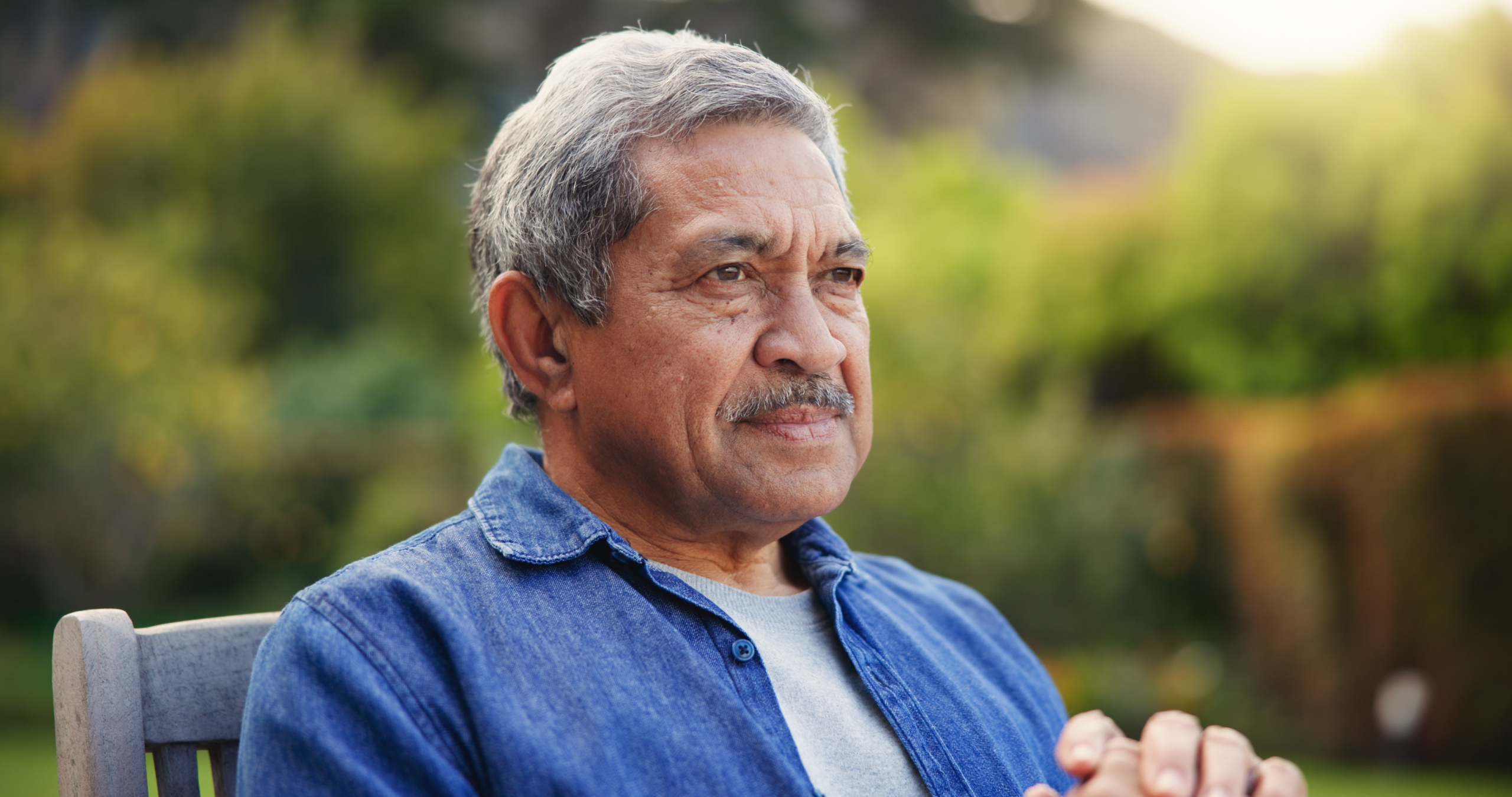 Elderly man on bench outdoors — why is dementia training important for families Elderly man on bench outdoors — why is dementia training important for families