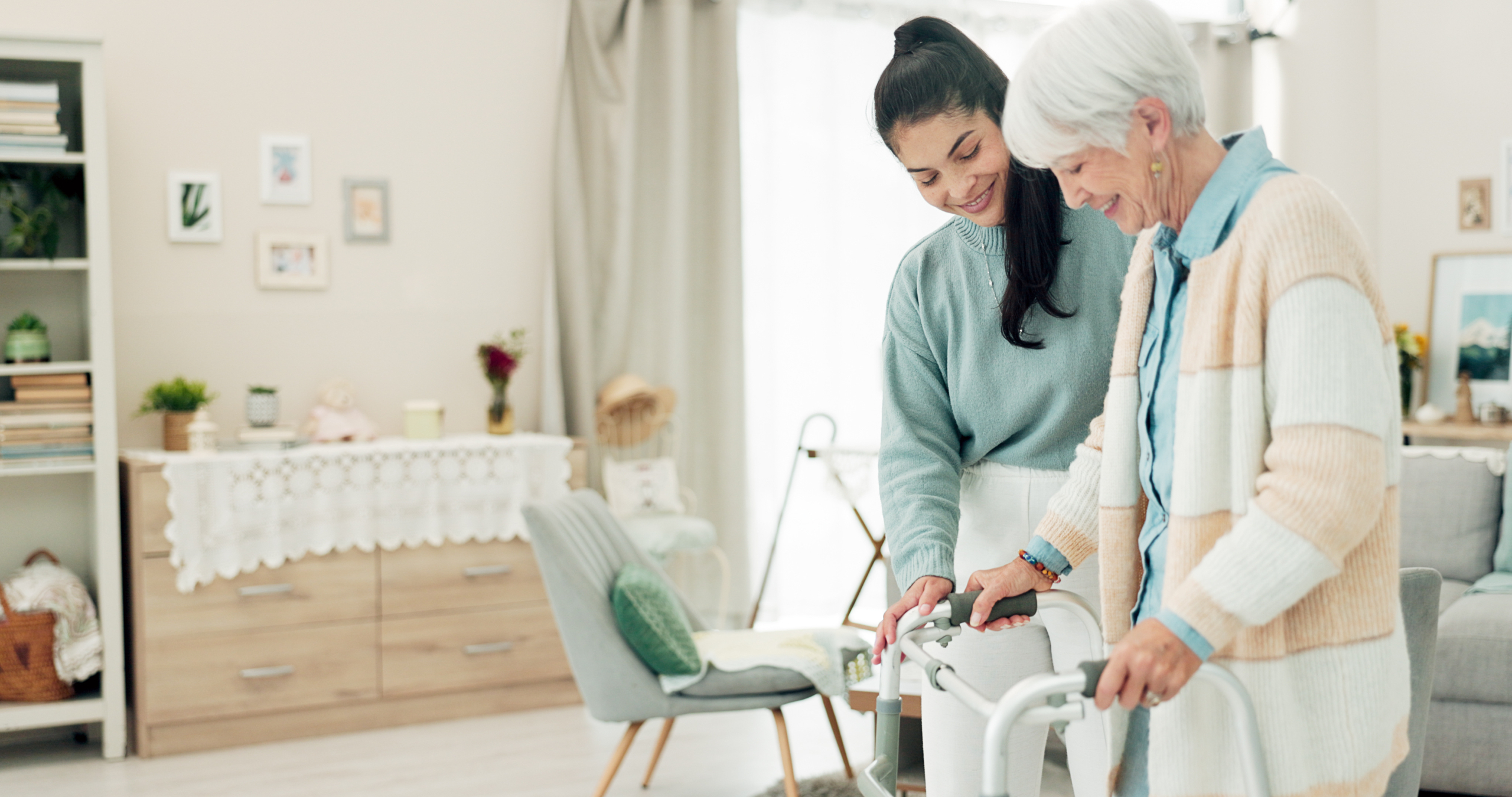 carer-helping-senior-walk-dementia-and-falls-prevention A carer supporting an older person while walking, part of dementia and falls prevention