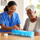 Carer supporting dementia and medication management at home with a daily pillbox routine
