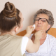 A family carer learning dementia awareness training techniques to support an elderly relative at home