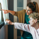 A trained carer providing dementia care training support to an elderly person at home in Lancashire