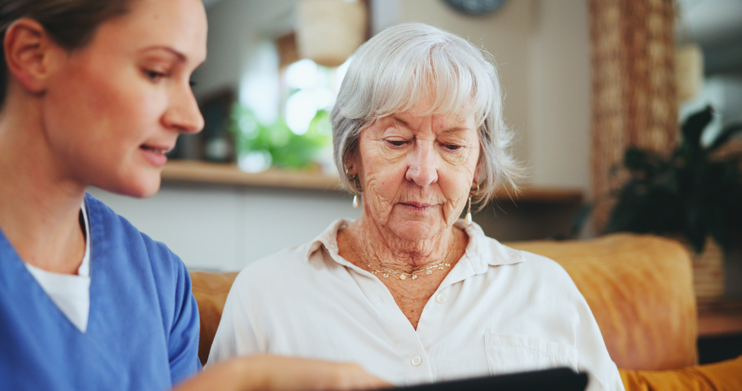 private-companion-for-elderly-near-me A carer and elderly woman sharing a conversation during a private companion visit at home in Lancashire, private companion for elderly near me.