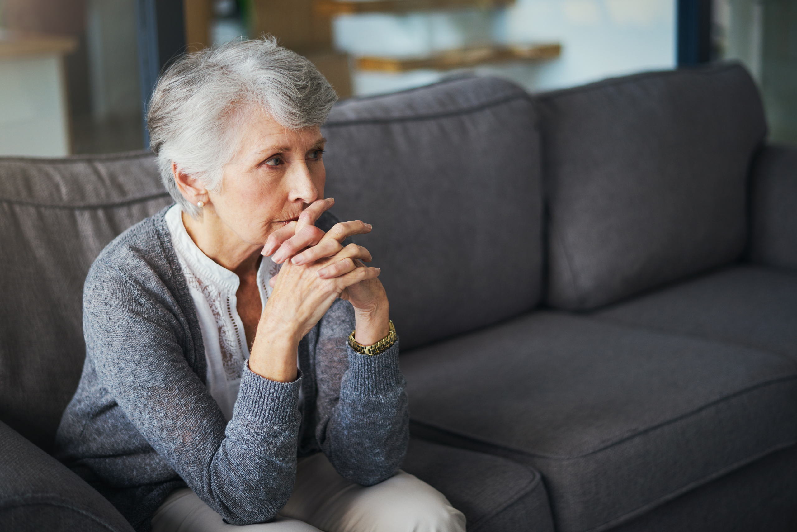 support-for-elderly-living-at-home-care A carer providing support for elderly living at home, sitting with an older woman in her living room in Lancashire