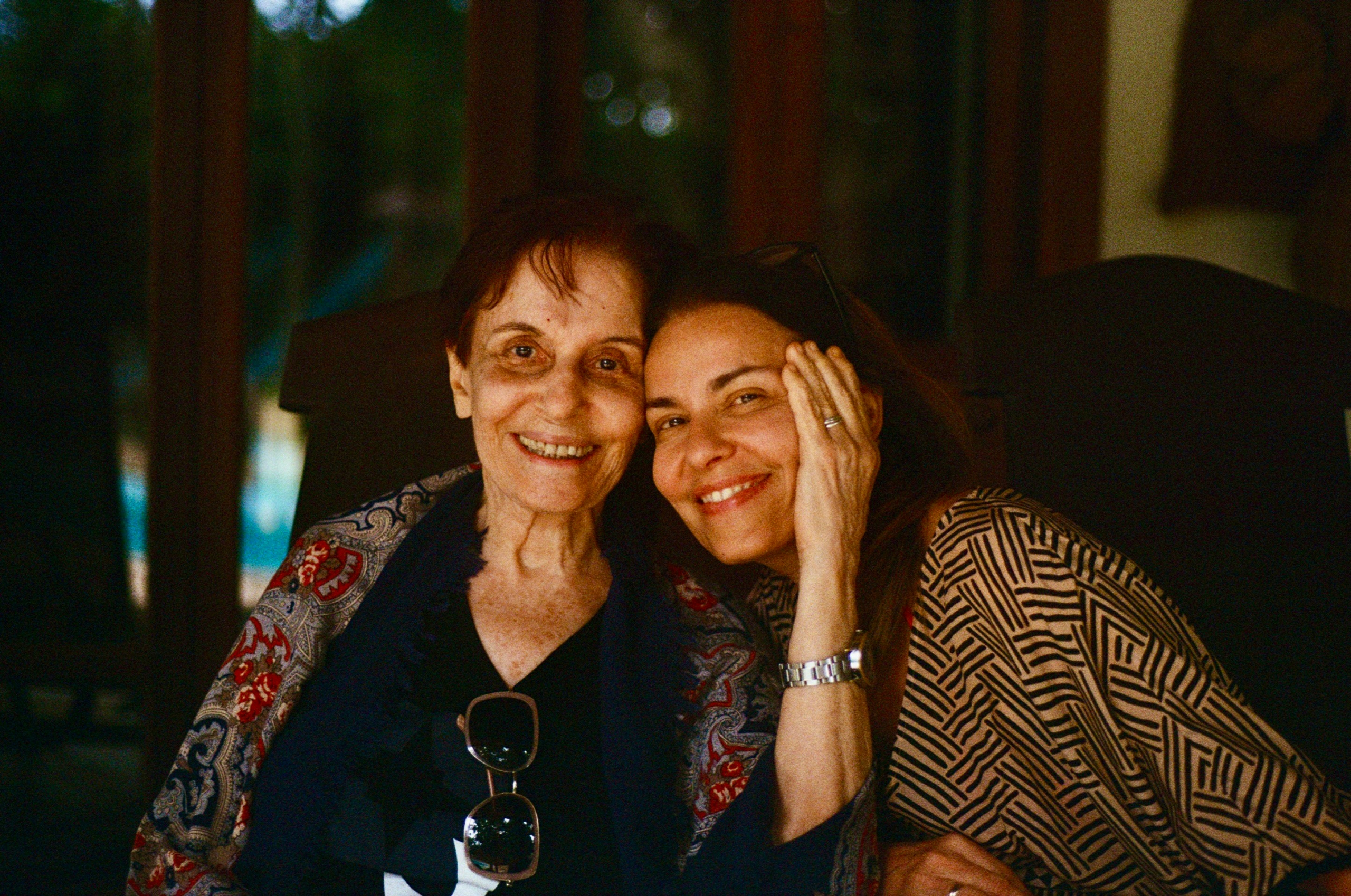 Mother and daughter sharing a warm embrace and smiling