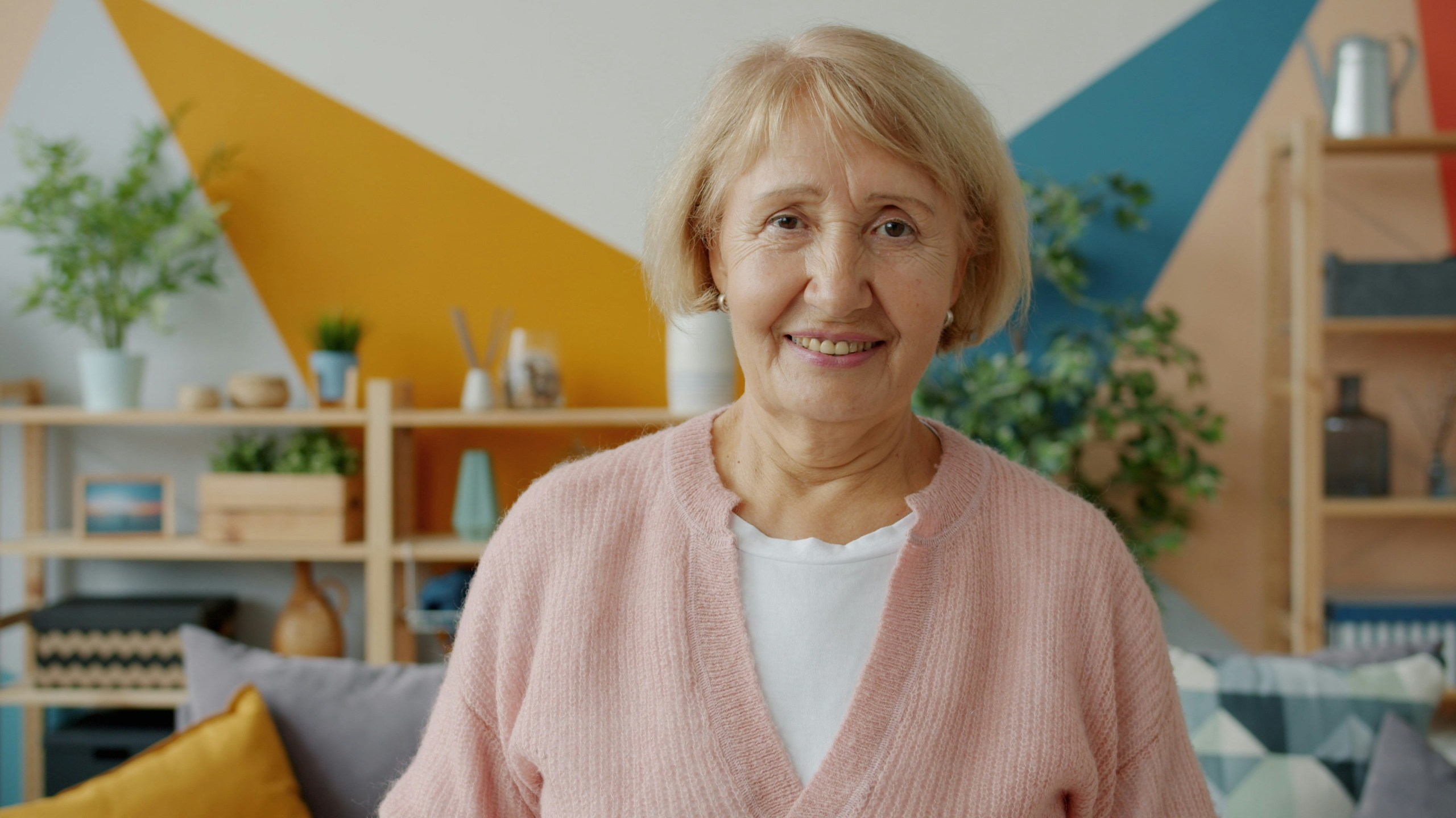 Smiling older woman sitting in her living room